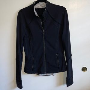 Black Define jacket with ruffle detail.